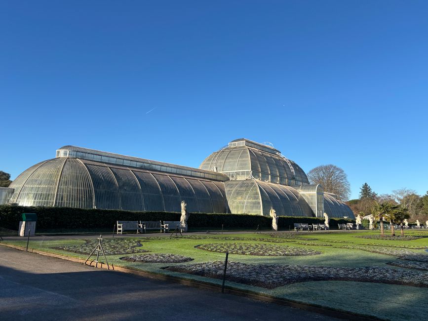Beautiful view of the historic Palm House at Kew Gardens, showcasing its Victorian architecture.